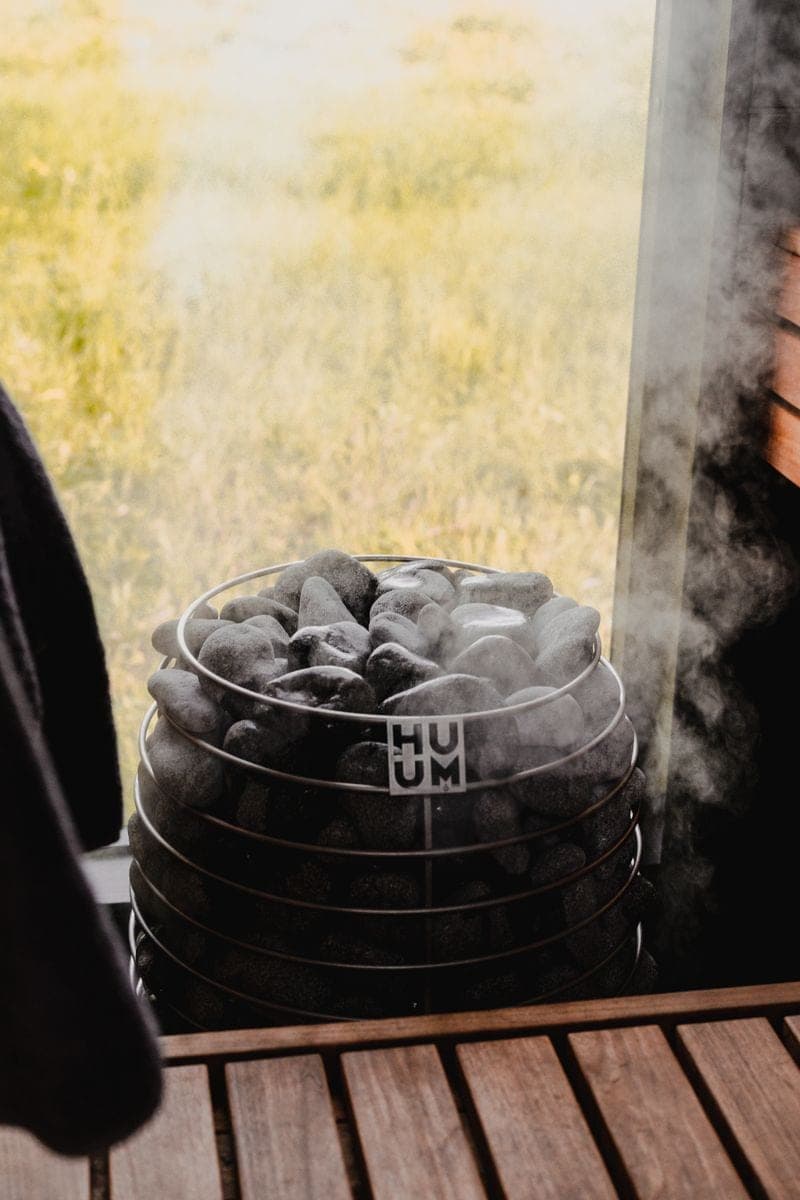 Steam rising off the stones of a sauna heater